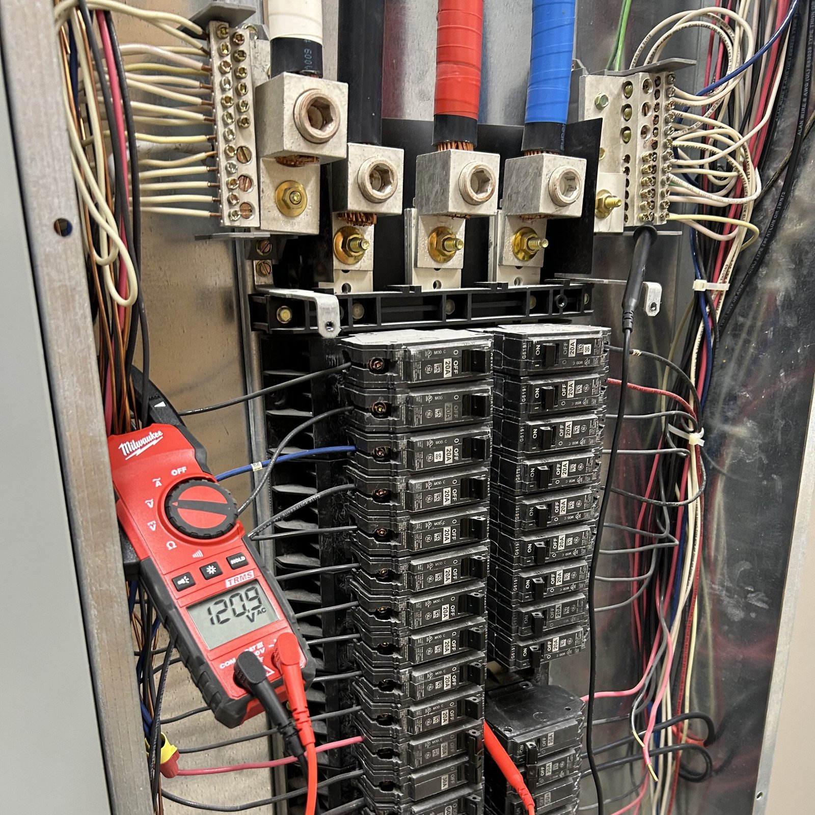 Voltage testing inside an electrical panel during an emergency electrical diagnosis
