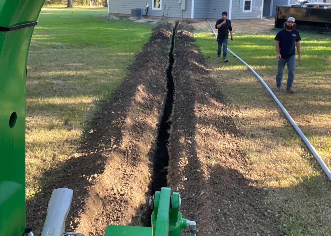 Open trench prepared for underground electrical wiring installation.