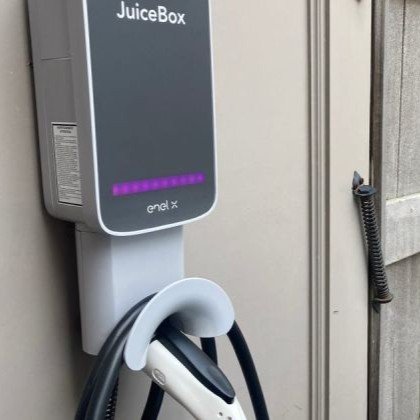 Electric car plugged into a residential charging station.