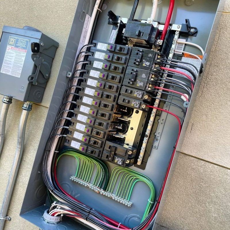 Electrical panel with well-organized circuits and labeled connections.