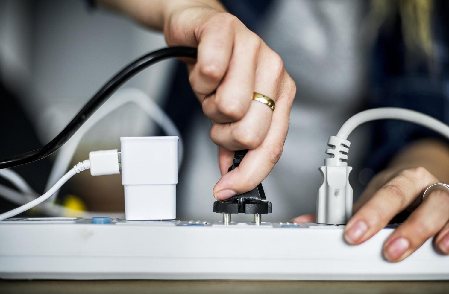 A homeowner in Metairie plugging in devices representing common household electrical issues.