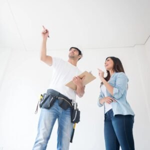 Homeowner going over an installation with an electrician after a successful service visit in front of their Metairie home.