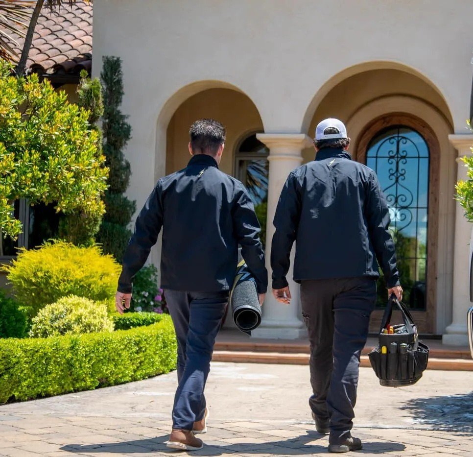 Two electricians arriving at a Metairie home, ready to provide professional residential electrical services.