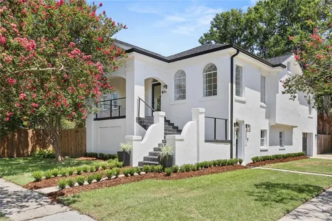 Exterior view of a traditional Metairie home with a well-maintained lawn, representing local residential properties in the Metairie area.