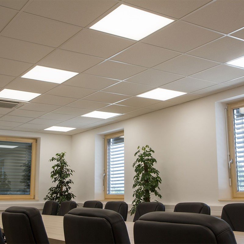 Energy-efficient LED overhead lighting in modern office meeting room.
