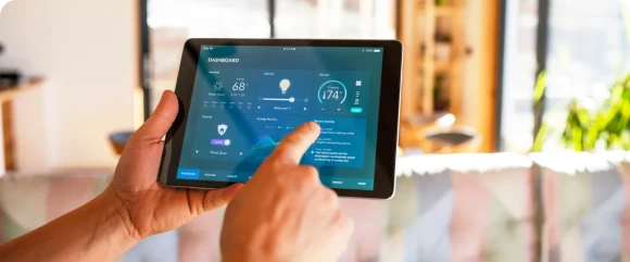 Homeowner using phone to operate smart home technology.