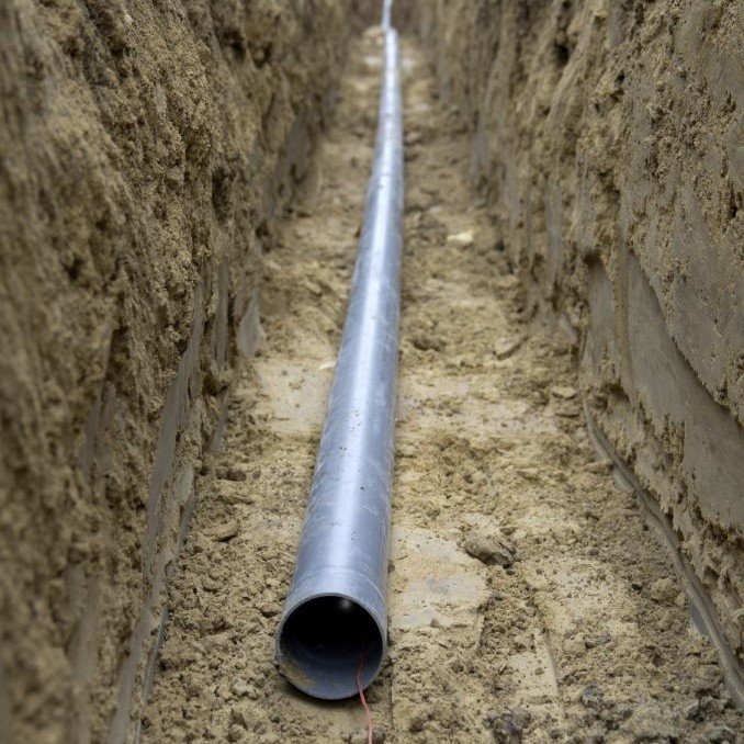 PVC conduit installed in trench for underground electrical wiring in Metairie.