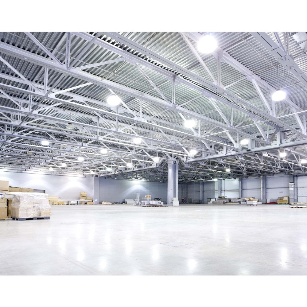 Spacious commercial warehouse interior illuminated by overhead LED lighting.