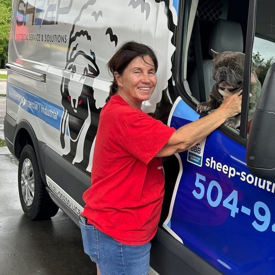 Sheep Electrical Service & Solutions service van with a smiling customer and dog, serving Metairie and New Orleans with local electrical repairs and installations.