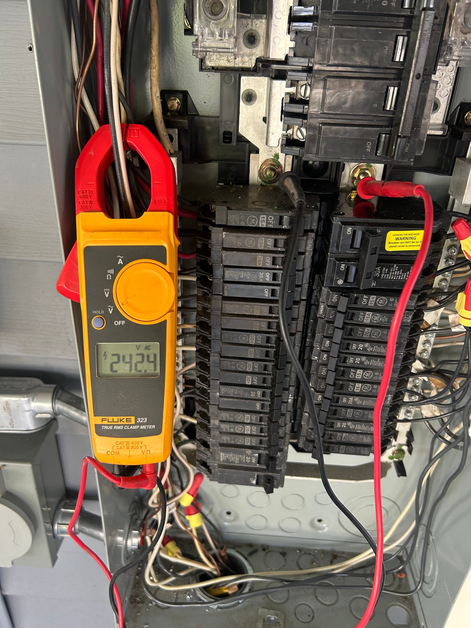 Licensed electrician testing a residential electrical panel with a digital meter during troubleshooting in Metairie and New Orleans.