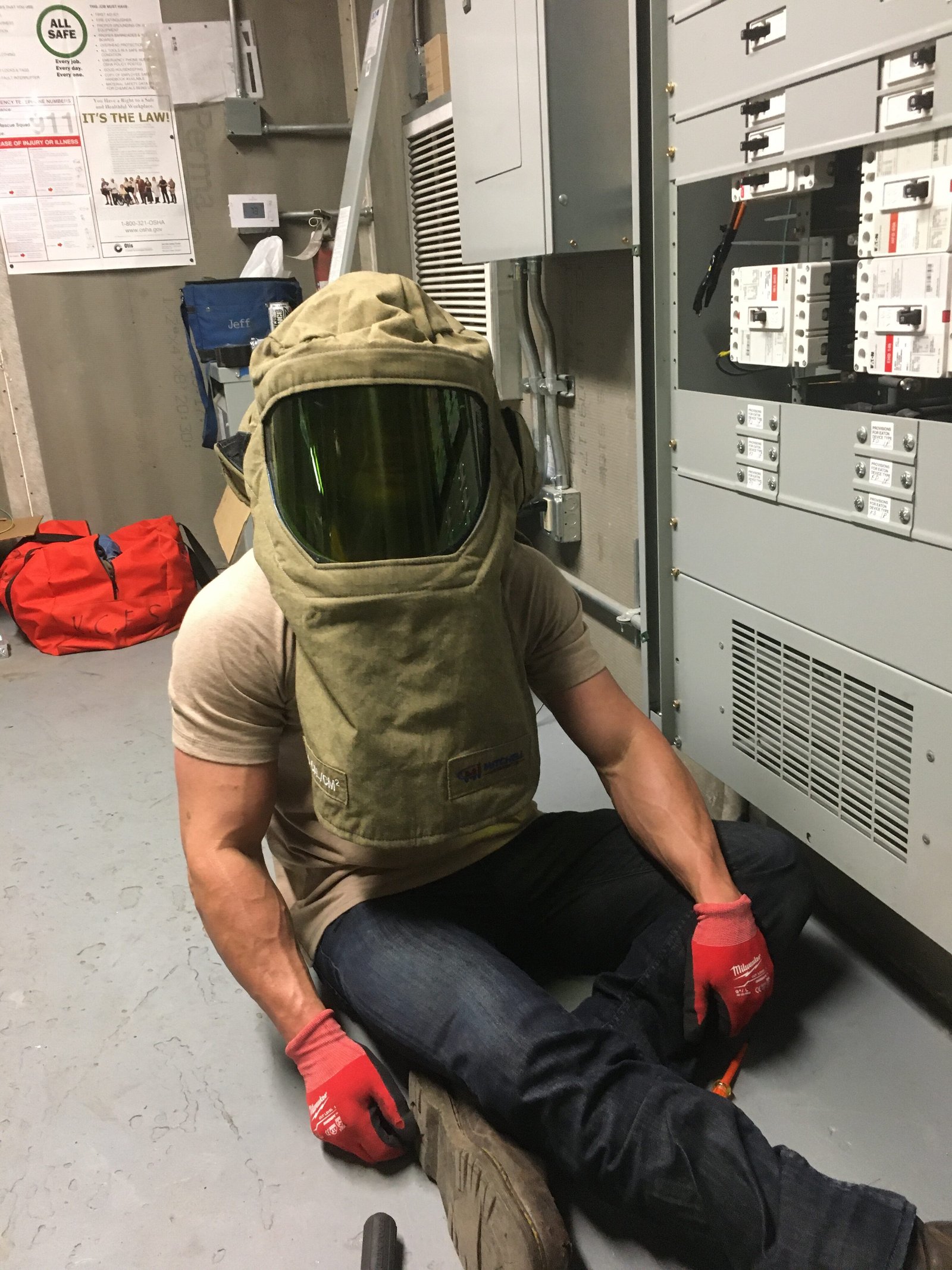 Licensed commercial emergency electrician wearing arc flash PPE while servicing commercial electrical equipment in New Orleans and Metairie.