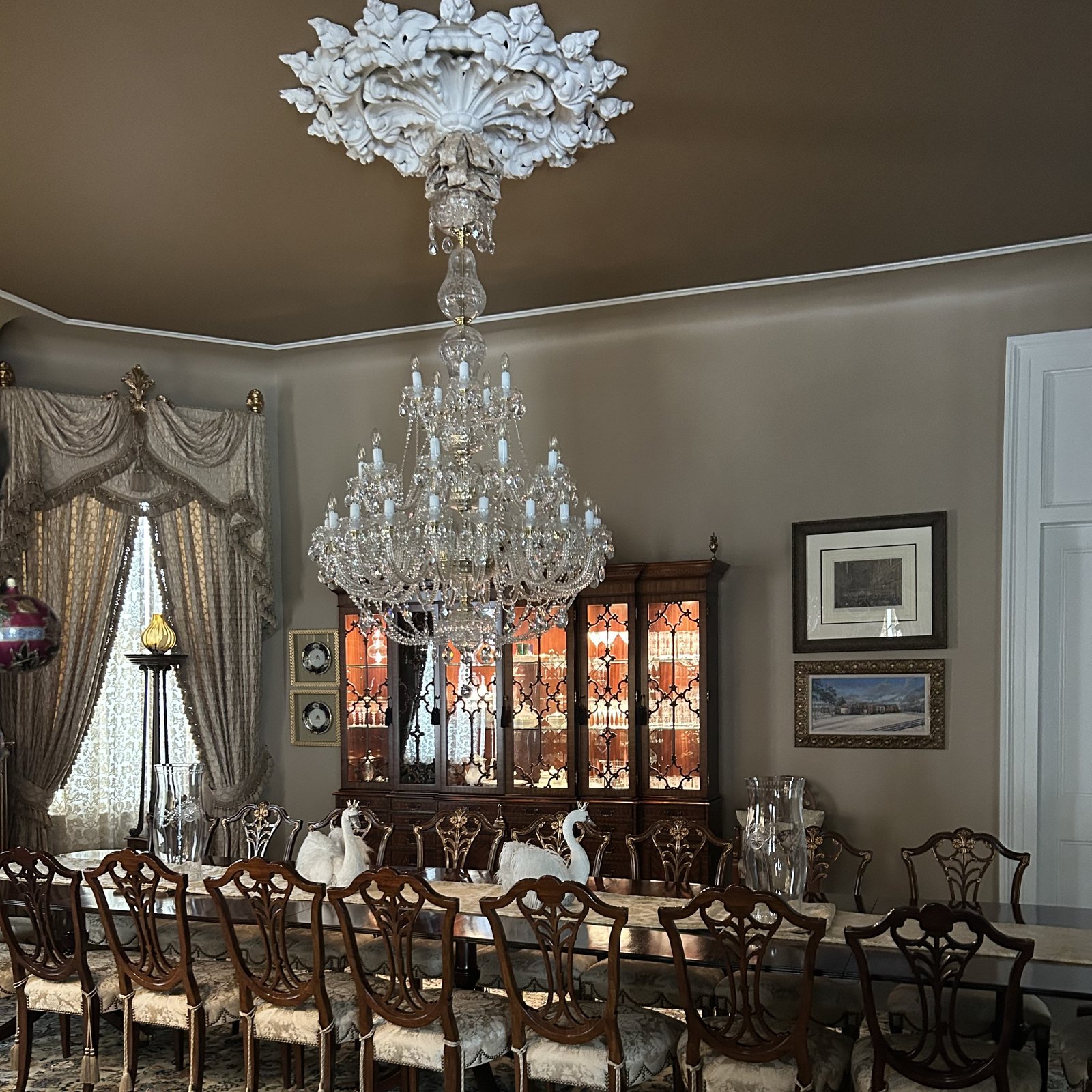 Large illuminated crystal chandelier in an elegant dining room