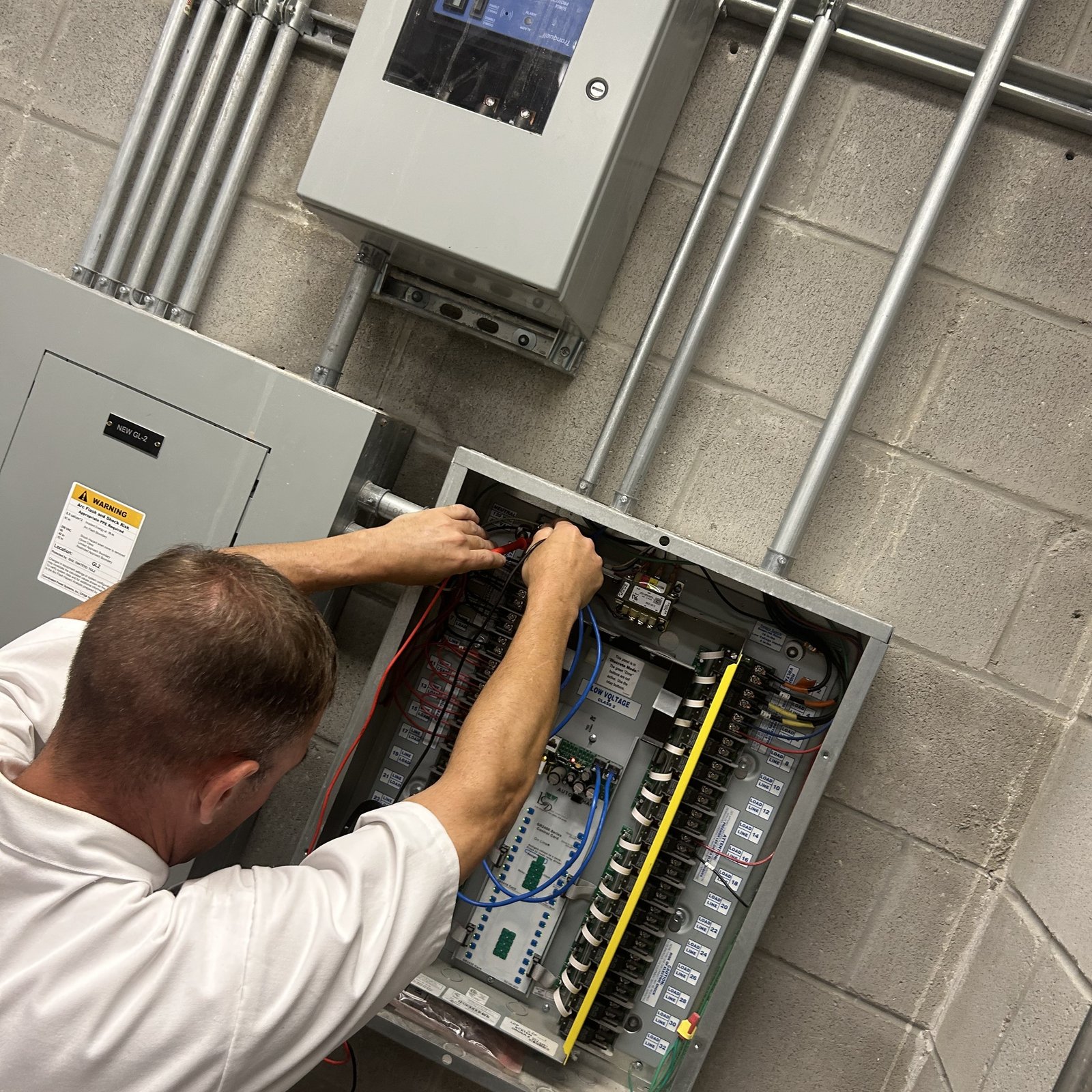 Sheep Electrical electrician troubleshooting an electrical control panel
